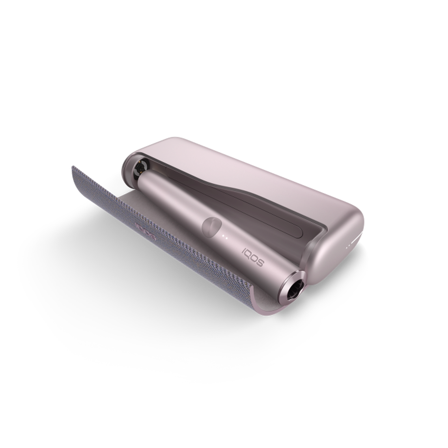 A Bronze Taupe IQOS ILUMA PRIME device inside a holder with the door open. 