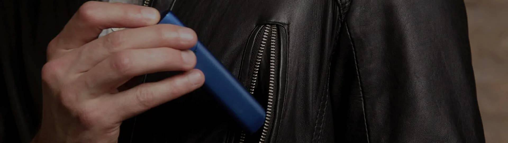 Man taking out of the pocket his IQOS 3 Multi