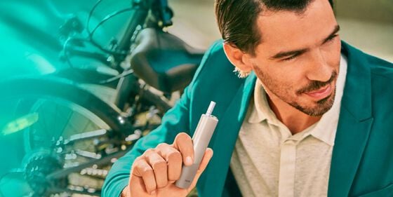 An IQOS ILUMA device and mobile phone.