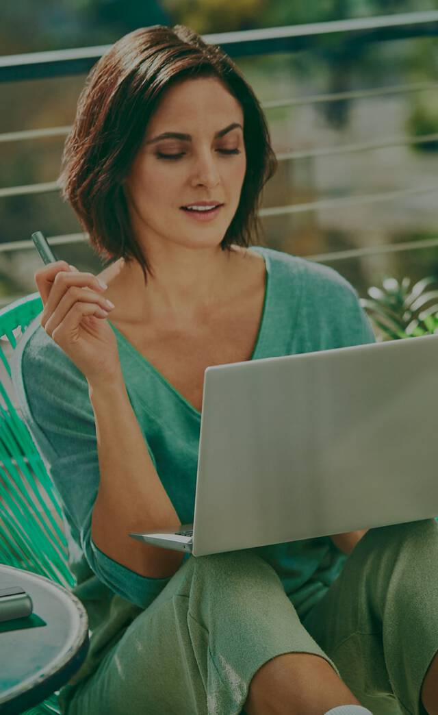 An IQOS ILUMA Pocket Charger and Holder on a laptop.