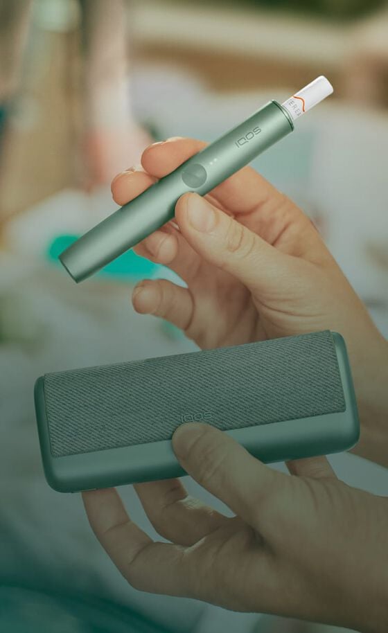 A jade green IQOS ILUMA PRIME Holder and Pocket Charger.