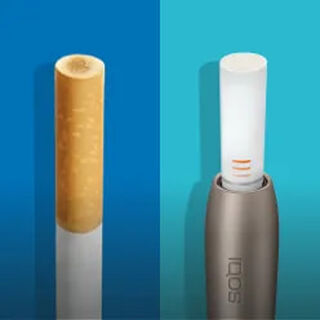 IQOS Originals Duo holder, next to a cigarette.